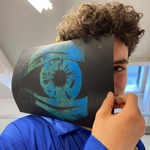 Student with artwork on art field day