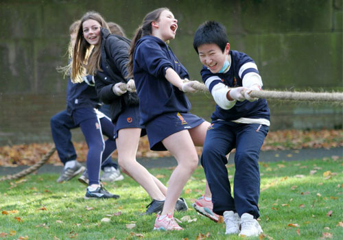 Students playing tug of war on their field day